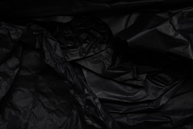 Black crumpled paper texture with copy space