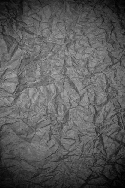 Black crumpled paper texture.