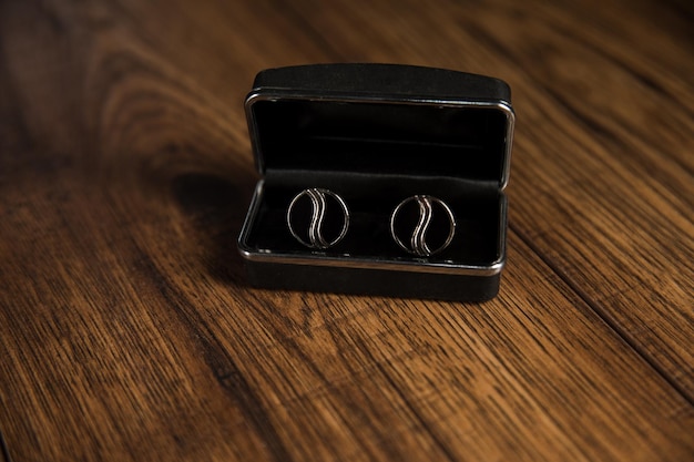 Photo black cufflinks on the table