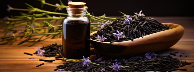 of black cumin essential oil on a wooden background