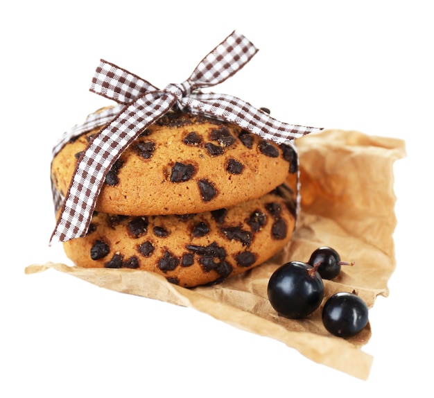 Black currants and cookies isolated on white