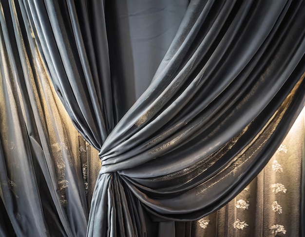 Photo black curtain or drapes with light spot abstract background luxury wavy black silk curtain decoratio...