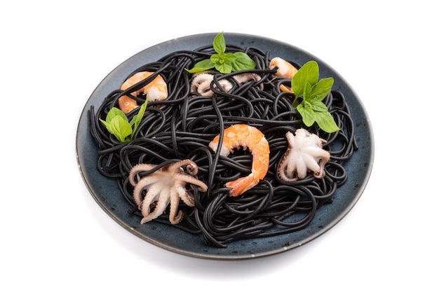 Black cuttlefish ink pasta with shrimps or prawns and small octopuses isolated on white surface