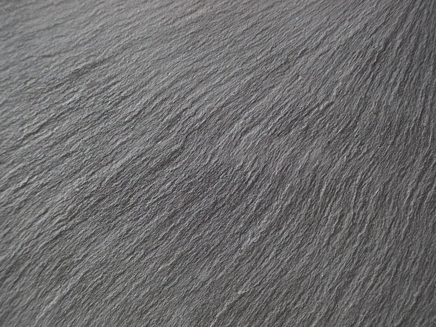 黒暗い灰色の自然なシームレスな石のテクスチャ背景。