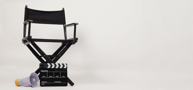 Photo black director chair and clapper board with yellow megaphone on white background