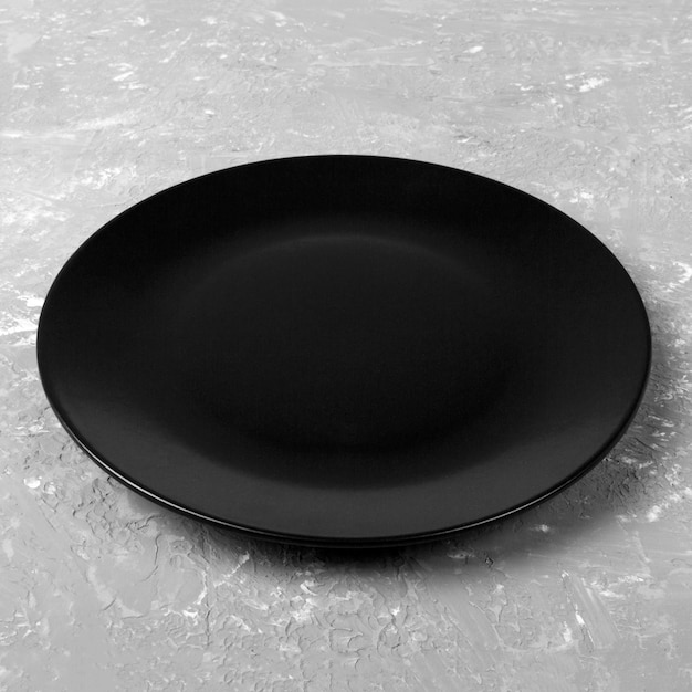 black dish on gray cement