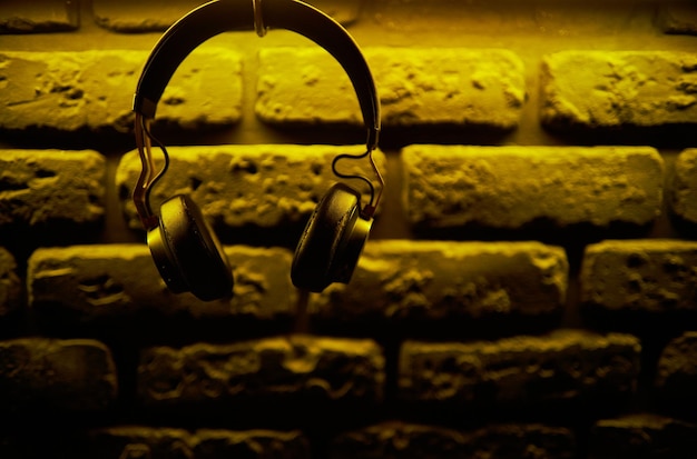 Black dj headphones on the background of the wall photo for
background musical background