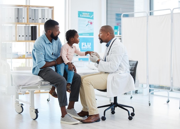 Black doctor medicine and medical worker consulting with baby father and child patient for covid allergies or hospital Nurse trust and support African family wellness healthcare for health help