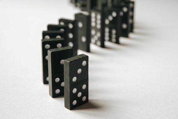 Black Dominoes game block in a row on a colored background Stock Photo -  Alamy