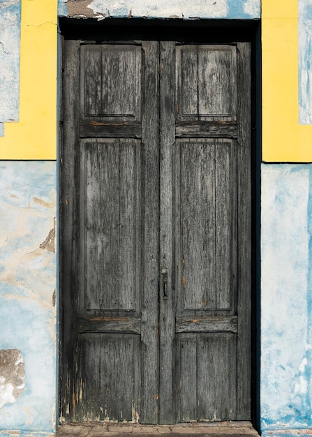 A black door with a yellow border and the word the word on it