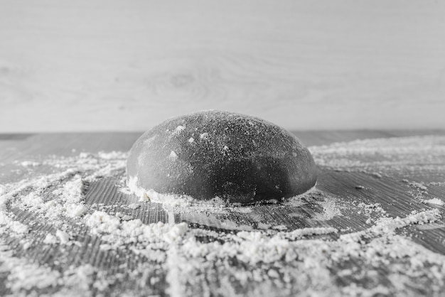 Black dough ball with flour