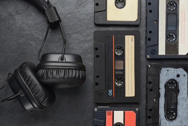 Photo black on-ear headphones and audio tape compact cassettes