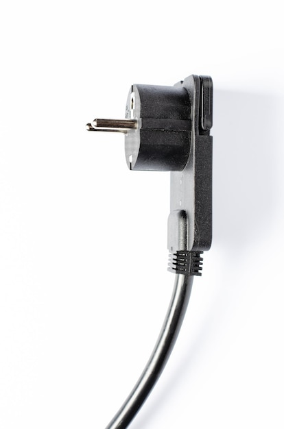 Black electric extension cord on a white background Closeup