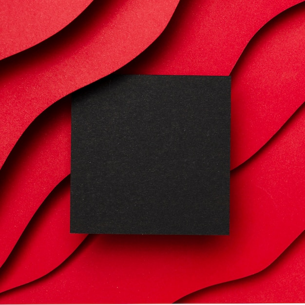 Black empty paper and wavy layers of red background