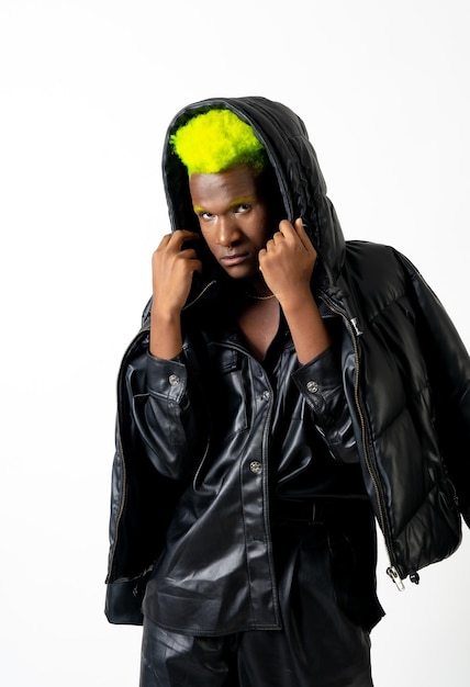 Black ethnic man in studio with white background LGTBI concept posed with leather jacket hat