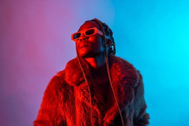 Black ethnic woman with braids with red and blue led lights studio shoot