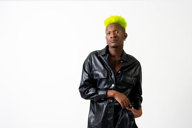 Black ethnicity man in studio with white background lgtbi\
concept fashion posed with black jacket