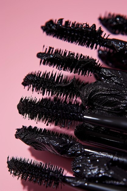 Photo black eyelash brushes on a pink background womens cosmetics face makeup