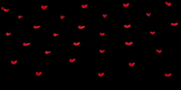 black fabric background with red hearts shapes