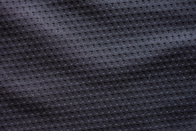 Черная ткань спортивной одежды футбольный трикотаж с воздушной сеткой текстуры фона