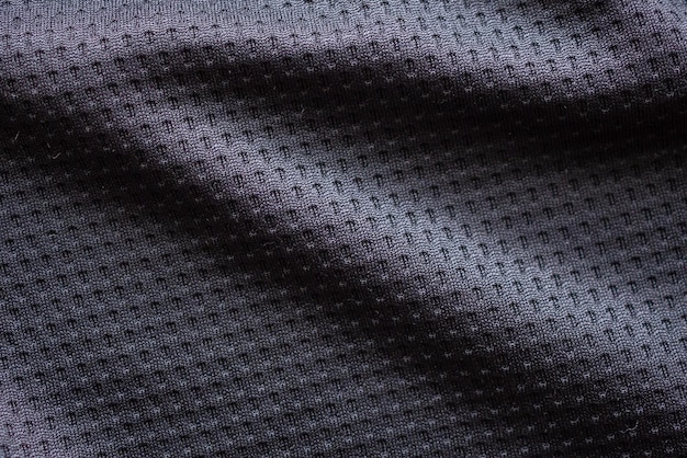 Черная ткань спортивной одежды футбольный трикотаж с воздушной сеткой текстуры фона