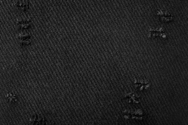 黒い布の質感。布製のダーク素材の背景。引き裂かれた繊維