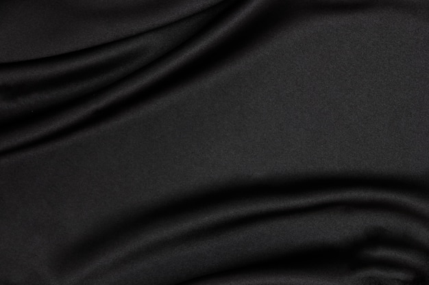 Photo black fabric texture background. smooth elegant black silk can use as wedding background.