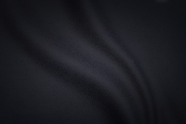 Black fabric texture background, wavy fabric slippery black color, luxury satin or silk or wool cloth texture.