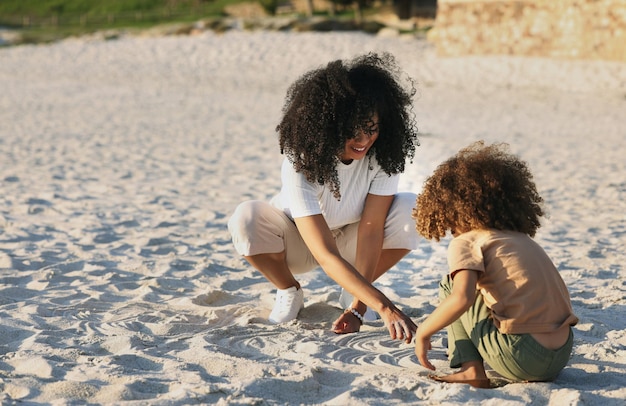 Black family at the beach mother and child play in sand on summer holiday freedom and travel with nature outdoor Fun together vacation and carefree with happiness woman and girl in Jamaica