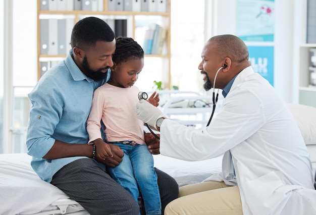 Black family girl and pediatrician doctor with stethoscope consulting healthcare worker or medical employee Kids happy father with smile or trust pediatrician in hospital insurance test for heart