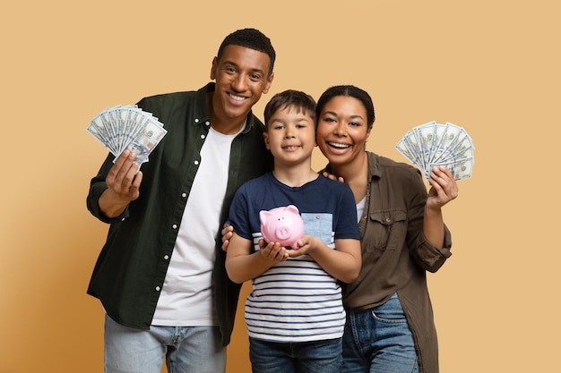 Photo black family holding money cash and piggy bank