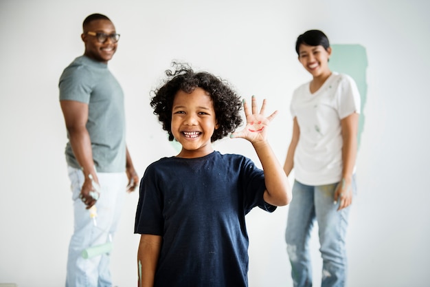 Black family painting house wall