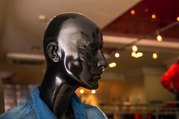 Black fashion mannequin head in a store. Copy space