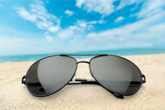 Premium Photo | Black fashion sunglasses on sand background