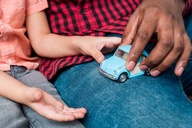 写真 黒の父と息子の小さなおもちゃの車で遊ぶ