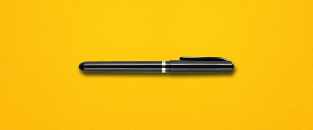 Black felt pen isolated on yellow banner background