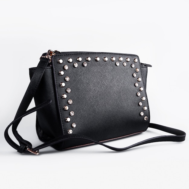 Black female leather bag isolated on white.