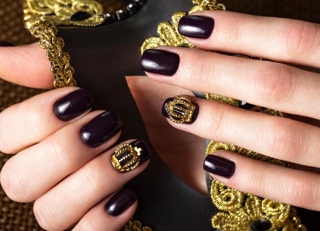 Black female manicure nails closeup with crown.