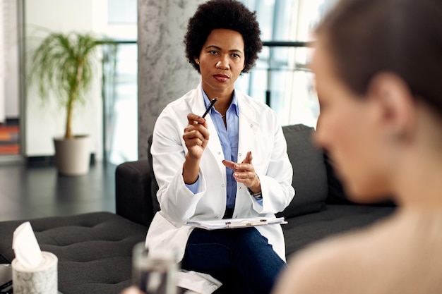 Black female psychotherapist having an appointment with patient\
at her office