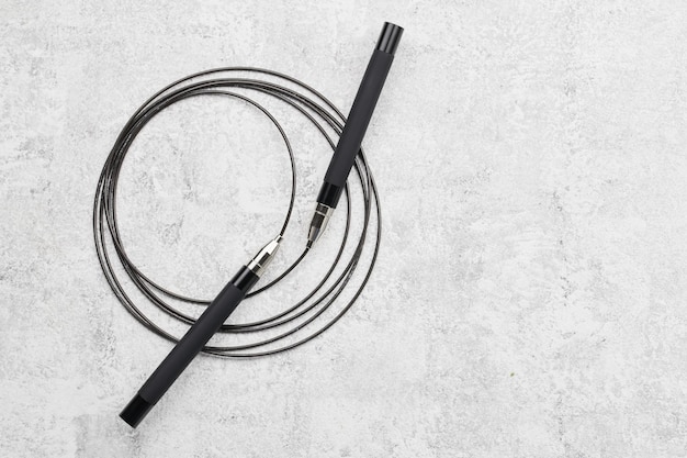 Black fitness skipping rope closeup isolated on white gray background crossfit sports equipment