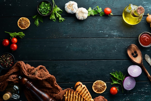 Black food background Vegetables and spices on black background Top view Free space for your text