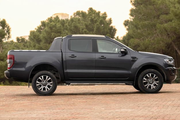 A black ford ranger is parking on a driveway