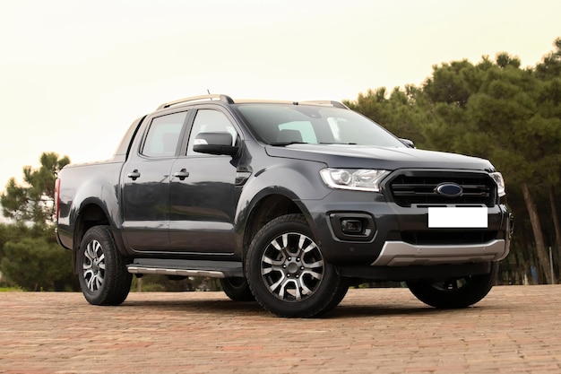 A black ford ranger is parking on a driveway