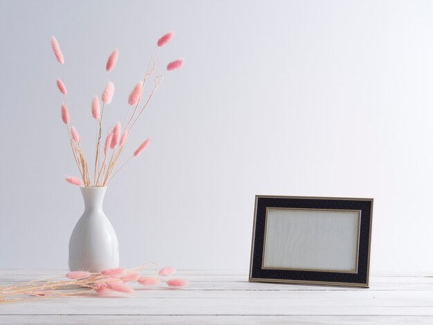 Black frame mockup with grass flowers.