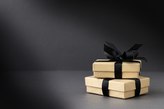 Black friday background with gift boxes on black surface