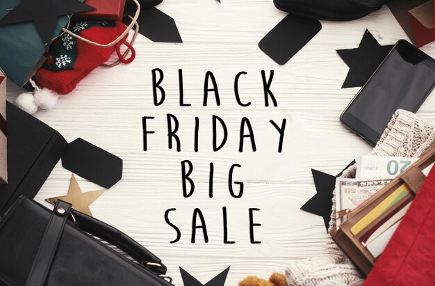 Photo black friday big sale text sign special discount christmas offer advertising message at gift boxes price tags credit cards money bags wallet on rustic background christmas shopping