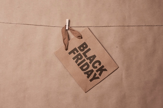 Photo black friday concept craft shopping bags on the rope