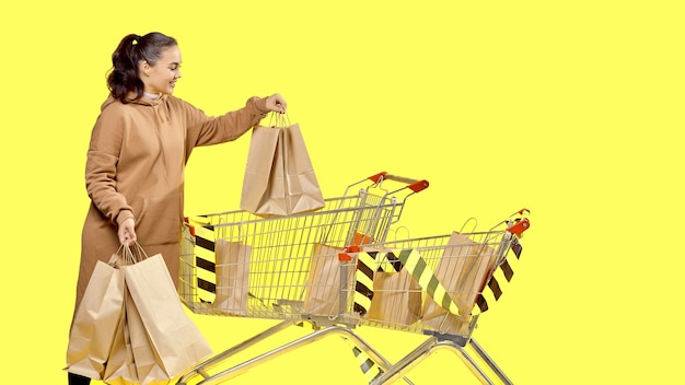 Black Friday, a girl takes shopping bags out of the cart