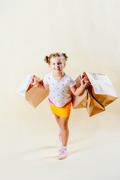 Black Friday. Little blonde girl holds craft packages 