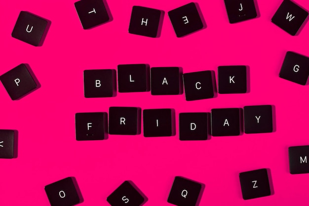 Photo black friday. the phrase from the keyboard buttons. pink background.